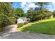 View of the exterior of a well-maintained house with a long driveway and lush green lawn at 165 Lost Lake Trl, Villa Rica, GA 30180