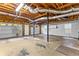 Unfinished two-car garage with exposed wood framing, concrete floor, and overhead lighting at 165 Lost Lake Trl, Villa Rica, GA 30180