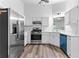 Kitchen features stainless steel appliances, sleek countertops, and recessed lighting at 165 Lost Lake Trl, Villa Rica, GA 30180