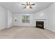 Bright and open living room featuring a fireplace and neutral carpet, door to the side at 165 Lost Lake Trl, Villa Rica, GA 30180