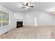 Spacious living room featuring a fireplace, neutral carpet, ceiling fan and bright window at 165 Lost Lake Trl, Villa Rica, GA 30180