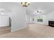 Open living room with neutral walls, fireplace, carpeted floor, and lots of light at 165 Lost Lake Trl, Villa Rica, GA 30180