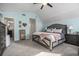 Large, carpeted bedroom with vaulted ceiling and large bed with decorative pillows at 4271 Keheley Ne Rd, Marietta, GA 30066