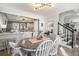 Open dining room connected to the modern kitchen, features stairs, and natural light at 4271 Keheley Ne Rd, Marietta, GA 30066