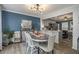 Dining room with blue accent wall, wood-style floors, and an adjacent kitchen area at 4271 Keheley Ne Rd, Marietta, GA 30066