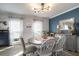 Dining room with stylish lighting, blue accent wall, and neutral-toned furniture at 4271 Keheley Ne Rd, Marietta, GA 30066