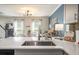 Gourmet kitchen with island seating overlooking the dining area, stainless faucet, and pendant lighting at 4271 Keheley Ne Rd, Marietta, GA 30066