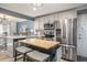 Kitchen featuring a stainless steel fridge, breakfast bar, and modern appliances at 4271 Keheley Ne Rd, Marietta, GA 30066
