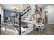 Stairway with contrasting black and white rails leading to an upstairs floor. Entryway view at 4271 Keheley Ne Rd, Marietta, GA 30066