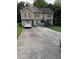 Two-story home with neutral siding, double windows, and extended driveway at 120 Alfred Dr, Carrollton, GA 30116