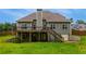 A rear view of the home highlighting the wooden deck and large lawn at 168 Gatlin Ridge Run, Dallas, GA 30157