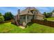 The back of the home with a deck, fenced-in backyard, and lush green grass at 168 Gatlin Ridge Run, Dallas, GA 30157