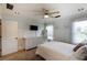 Serene bedroom offers beadboard accent wall, plush carpet, bright natural light, and modern ceiling fan at 168 Gatlin Ridge Run, Dallas, GA 30157