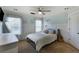 Bedroom features a large window, soft carpet, a modern ceiling fan, and stylish neutral decor at 168 Gatlin Ridge Run, Dallas, GA 30157