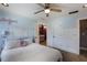 Bright bedroom with a guitar, soft carpet, beadboard accents, and an adjacent bathroom at 168 Gatlin Ridge Run, Dallas, GA 30157