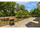 An outdoor deck with a grill and wooded backyard at 168 Gatlin Ridge Run, Dallas, GA 30157