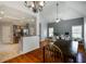 Dining room with view to kitchen and office space, hardwood floors, and bright chandelier at 168 Gatlin Ridge Run, Dallas, GA 30157