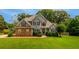 Charming two-story home with a well-manicured lawn and mature trees at 168 Gatlin Ridge Run, Dallas, GA 30157