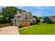 Beautifully landscaped home with green grass and long driveway at 168 Gatlin Ridge Run, Dallas, GA 30157