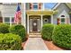 Inviting front entrance with manicured landscaping and an American flag at 168 Gatlin Ridge Run, Dallas, GA 30157