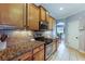 Gas range, oven, tile backsplash and granite countertops accent this kitchen space at 168 Gatlin Ridge Run, Dallas, GA 30157