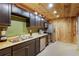 Kitchen boasts stainless appliances, dark cabinets, and wood walls at 168 Gatlin Ridge Run, Dallas, GA 30157