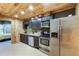 The kitchen features stainless steel appliances and dark cabinets at 168 Gatlin Ridge Run, Dallas, GA 30157