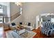 Inviting living room with hardwood floors, area rug, and comfortable sectional sofa at 168 Gatlin Ridge Run, Dallas, GA 30157