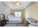 Comfortable main bedroom featuring a tray ceiling, ceiling fan, and neutral carpet at 168 Gatlin Ridge Run, Dallas, GA 30157