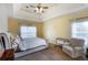 Comfortable main bedroom featuring a tray ceiling, ceiling fan, and neutral carpet at 168 Gatlin Ridge Run, Dallas, GA 30157