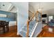 Elegant staircase with wood and iron railings, adjacent to a formal dining area at 168 Gatlin Ridge Run, Dallas, GA 30157