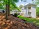 A beautiful backyard featuring a white home, gazebo, manicured lawn, and wooded backdrop at 1808 Jacksons Creek Dr, Marietta, GA 30068