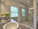 Modern bathroom with a glass-enclosed shower, granite countertop, and window with natural light at 1808 Jacksons Creek Dr, Marietta, GA 30068