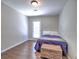 Simple bedroom with bed, hardwood floors, and natural light streaming in at 1808 Jacksons Creek Dr, Marietta, GA 30068