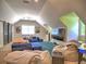 Spacious bonus room with plush seating, modern entertainment, and unique barn door access at 1808 Jacksons Creek Dr, Marietta, GA 30068