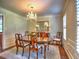 Elegant dining room with a chandelier, hardwood floors, and plantation shutters at 1808 Jacksons Creek Dr, Marietta, GA 30068
