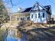 Charming lakeside home with covered porch, deck, and manicured yard at 1808 Jacksons Creek Dr, Marietta, GA 30068