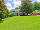 Lovely two-story home with lush green lawn, mature trees, and a front balcony at 1808 Jacksons Creek Dr, Marietta, GA 30068