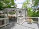 Outdoor gazebo with a table and chairs, lights, fountain and a white wooden fence on a grey wooden deck at 1808 Jacksons Creek Dr, Marietta, GA 30068