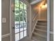 Hallway to the outside, with a staircase and a wall light at 1808 Jacksons Creek Dr, Marietta, GA 30068