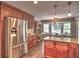 Kitchen featuring stainless steel refrigerator, cherry wood cabinets and an adjacent breakfast nook at 1808 Jacksons Creek Dr, Marietta, GA 30068