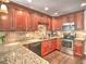 Cherry wood cabinets, stainless appliances and granite countertops create a modern kitchen space at 1808 Jacksons Creek Dr, Marietta, GA 30068
