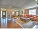 Open-concept living room with hardwood floors, multiple seating areas, and natural light at 1808 Jacksons Creek Dr, Marietta, GA 30068
