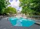 Stunning pool area with crystal clear water, diving board, and relaxing lounge chairs surrounded by green trees at 1808 Jacksons Creek Dr, Marietta, GA 30068