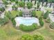 Aerial view of community pool with lounge chairs and a clubhouse surrounded by lush landscaping in a neighborhood at 2165 Capella Cir, South Fulton, GA 30331