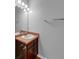 Bathroom featuring wood cabinets, a white sink, and an oversized mirror and lighting at 2165 Capella Cir, South Fulton, GA 30331