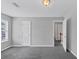 Neutral bedroom with gray walls and carpet, plus a window and access to the upstairs hallway at 2165 Capella Cir, South Fulton, GA 30331