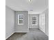 Bedroom featuring gray walls, neutral carpet, and two windows allowing for lots of light at 2165 Capella Cir, South Fulton, GA 30331