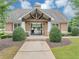 Community clubhouse featuring a welcoming entrance, neutral siding, and manicured landscaping at 2165 Capella Cir, South Fulton, GA 30331