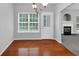 Dining area features hardwood floors, chandelier, a view of the backyard, and neutral walls at 2165 Capella Cir, South Fulton, GA 30331